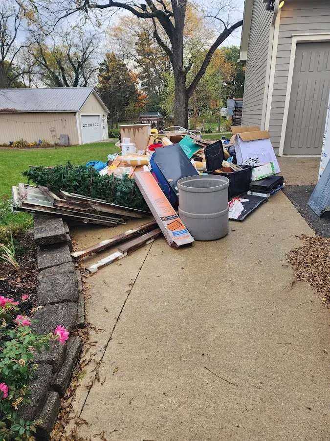 Dumpster being loaded with debris for Estate Cleanout Dumpster Rental in Gulf Gate